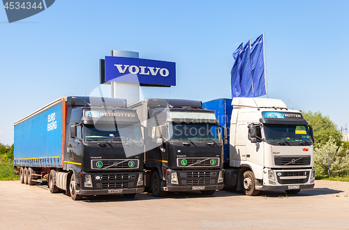 Image of Volvo trucks parked at the service station in summer day