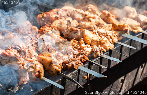 Image of Appetizing hot shish kebab on metal skewers