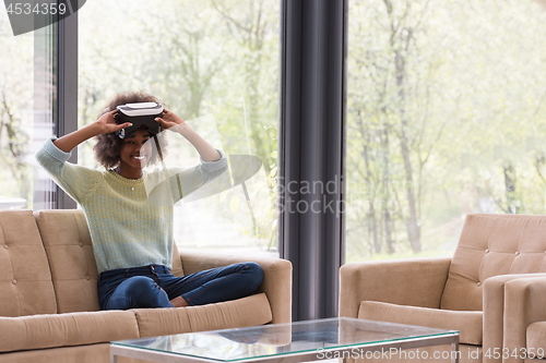 Image of black woman using VR headset glasses of virtual reality