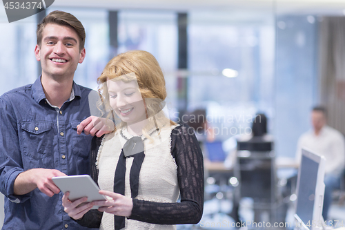 Image of Business People Working With Tablet in startup office