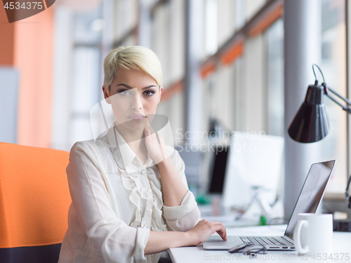 Image of businesswoman using a laptop in startup office