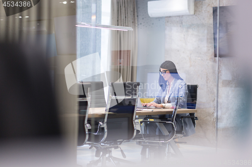 Image of businesswoman using a laptop in startup office