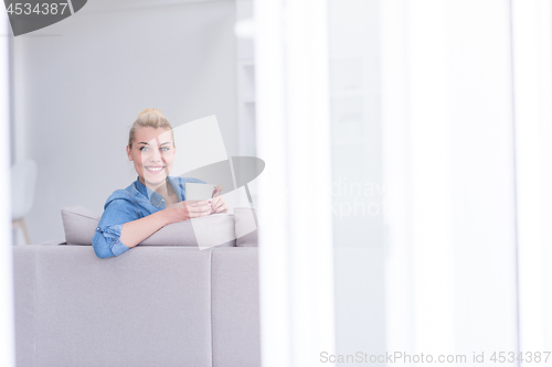 Image of woman enjoying a cup of coffee