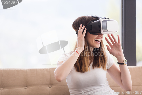 Image of woman using VR-headset glasses of virtual reality