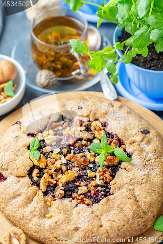Image of Homemade currant pie and a cup of green tea.
