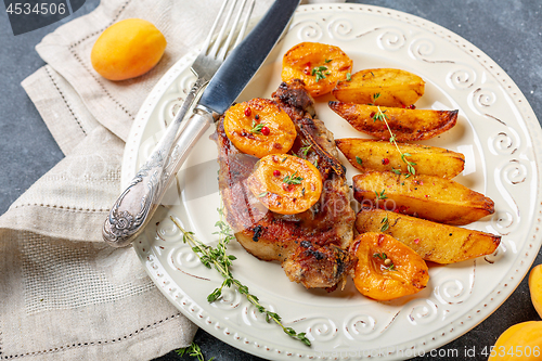 Image of Juicy pork steak with apricots,thyme and potatoes.