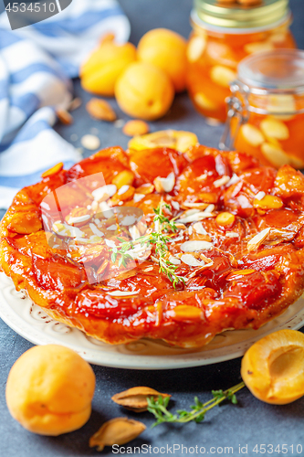 Image of Homemade tarte tatin pie with apricots and thyme.