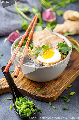 Image of Soup with noodles, pork and egg in Asian style.