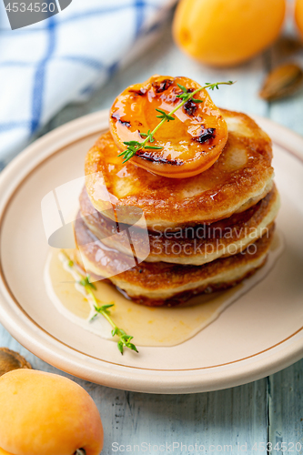 Image of Delicious pancakes with apricot jam and thyme.