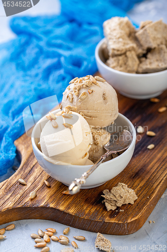 Image of Ice cream with seeds and halva in a white bowl.