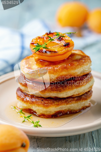 Image of Pancakes with apricot jam and thyme for breakfast.