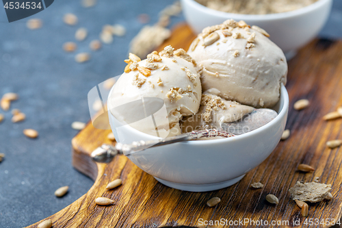 Image of Ice cream with halva and sunflower seeds close up.
