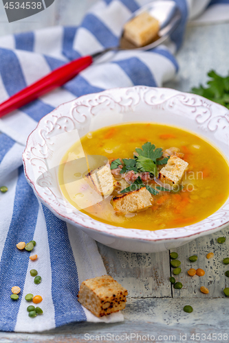 Image of Plate of thick pea soup with croutons.