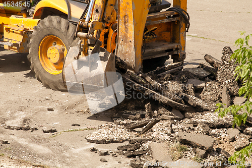 Image of Tractor Dismantles Asphalt