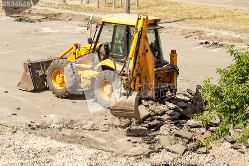 Image of Tractor Dismantles Asphalt