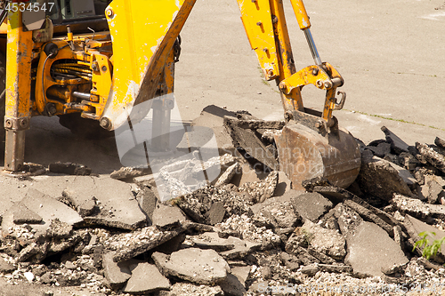 Image of Tractor Dismantles Asphalt