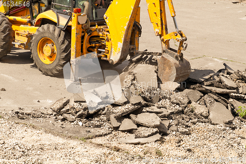 Image of Tractor Dismantles Asphalt