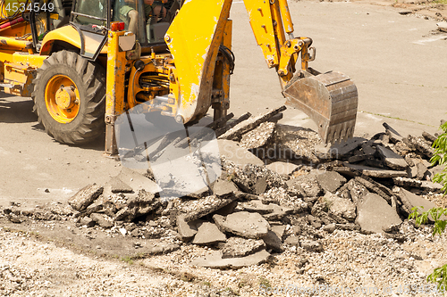 Image of Tractor Dismantles Asphalt