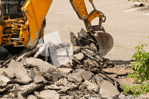 Image of Tractor Dismantles Asphalt