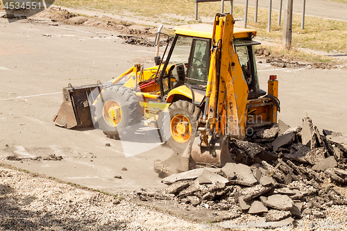 Image of Tractor Dismantles Asphalt