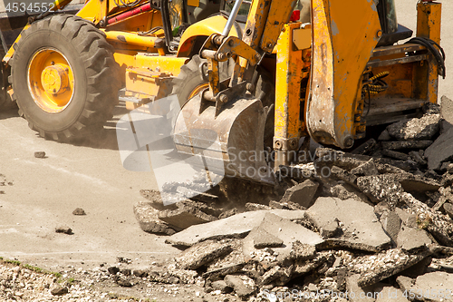 Image of Tractor Dismantles Asphalt