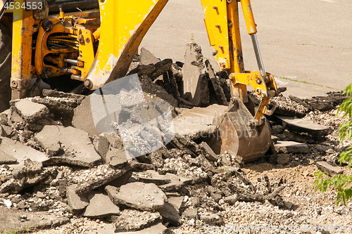 Image of Tractor Dismantles Asphalt