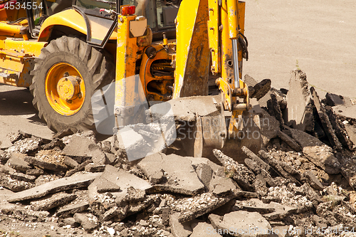 Image of Tractor Dismantles Asphalt