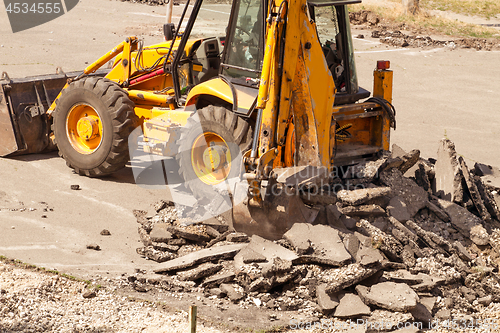 Image of Tractor Dismantles Asphalt