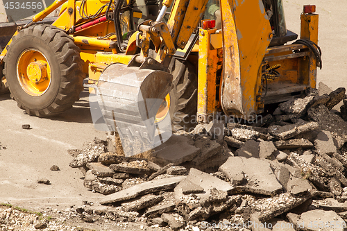 Image of Tractor Dismantles Asphalt