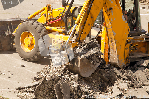 Image of Tractor Dismantles Asphalt