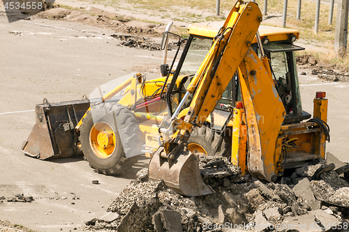 Image of Tractor Dismantles Asphalt