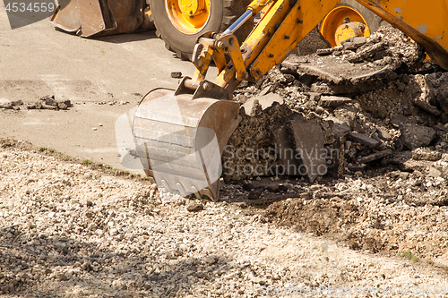 Image of Tractor Dismantles Asphalt