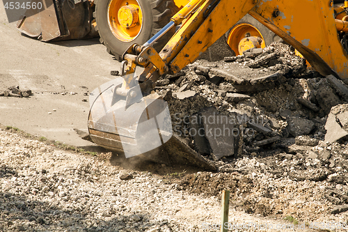 Image of Tractor Dismantles Asphalt