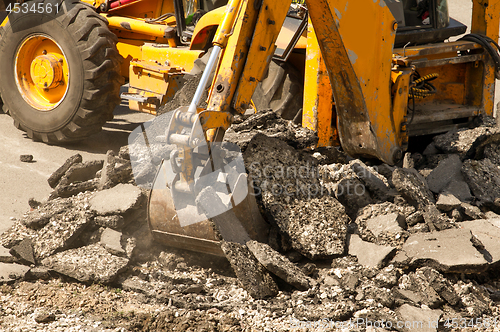 Image of Tractor Dismantles Asphalt