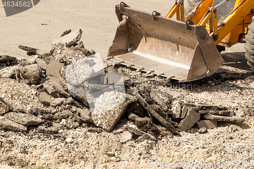 Image of Tractor Dismantles Asphalt