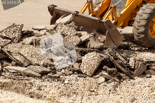 Image of Tractor Dismantles Asphalt