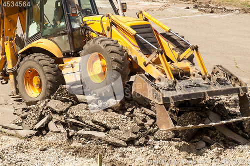 Image of Tractor Dismantles Asphalt