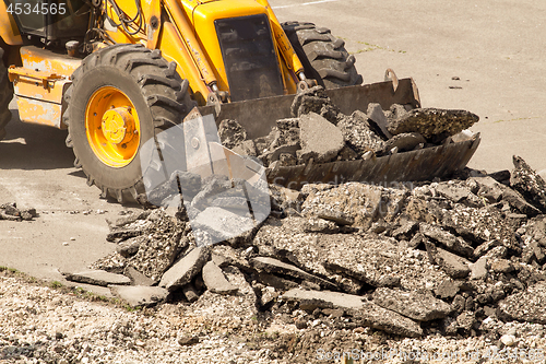 Image of Tractor Dismantles Asphalt