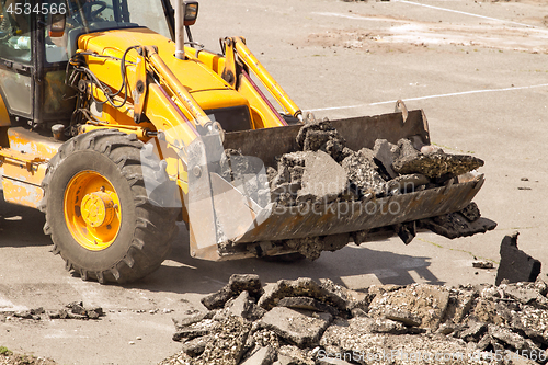 Image of Tractor Dismantles Asphalt