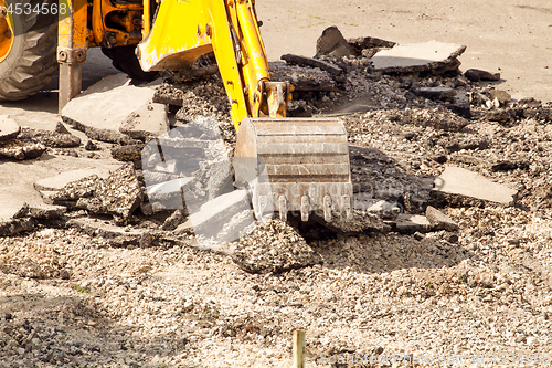 Image of Tractor Dismantles Asphalt