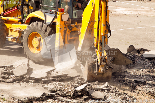 Image of Tractor Dismantles Asphalt