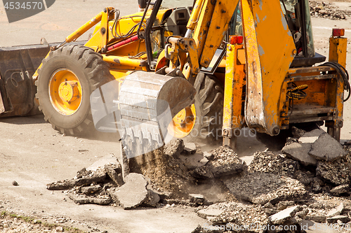 Image of Tractor Dismantles Asphalt