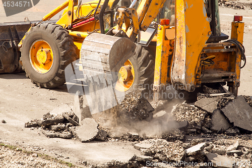 Image of Tractor Dismantles Asphalt