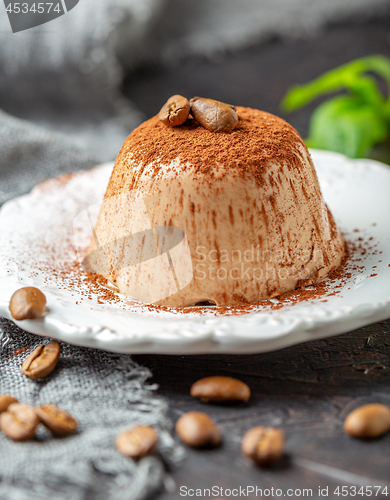 Image of Coffee Panna cotta sprinkled with cocoa powder.