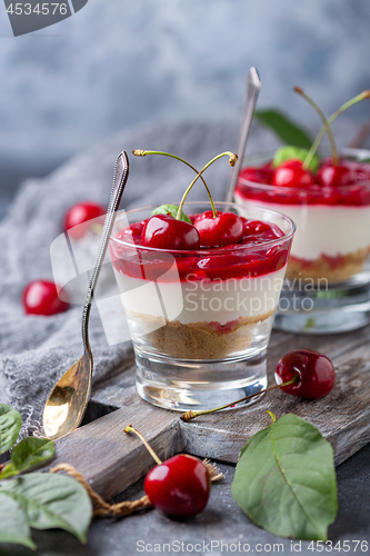 Image of Light cheesecake with cherry jelly in a glass.