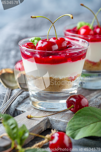 Image of Cheesecake with cherry jelly in a glass close-up.