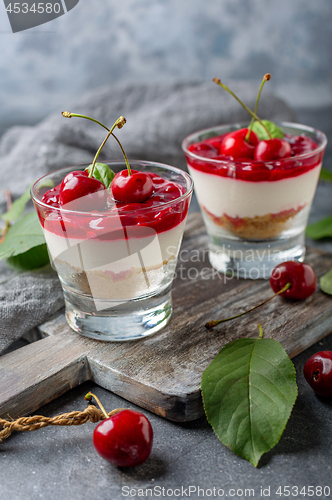 Image of Sweet cherry cheesecake in glasses.