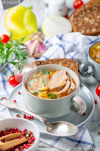 Image of Soup of fresh cabbage, meat and fresh herbs.