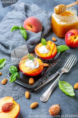 Image of Fresh grilled peaches with honey and green basil.