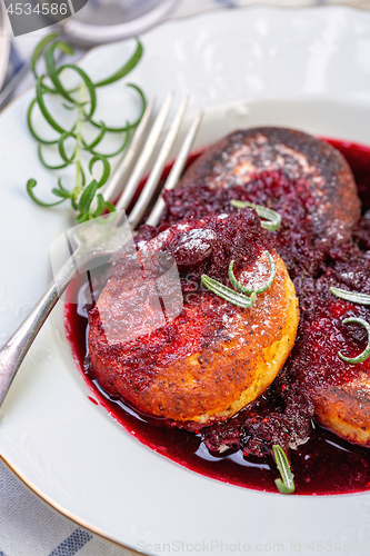 Image of Curd pancakes with cherry sauce with rosemary.